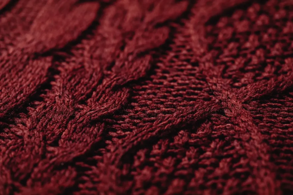 Close-up of a burgundy cable-knit textile