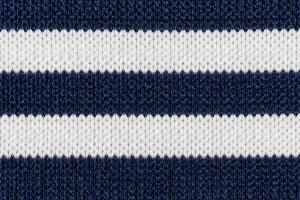 Double-Layer Acrylic Jacquard (Fan Scarf Knit): close-up of a navy and white acrylic jacquard scarf knit with block stripes