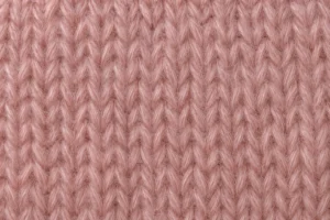 Mohair Yarn: close-up of a knitted swatch in dusty-pink mohair blend knitting yarn