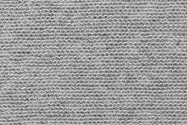 Close-up of the looped back of light-grey polyester French terry