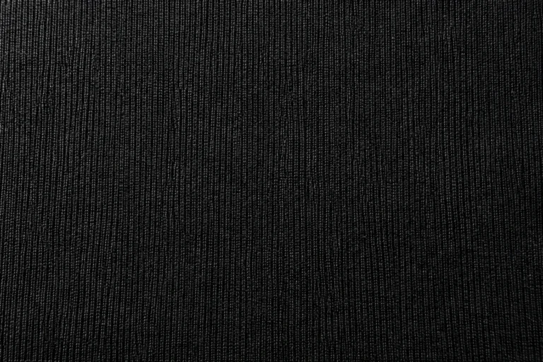 Polyester Tricot (Warp Knit): close-up of black polyester tricot with fine wales and a soft sheen