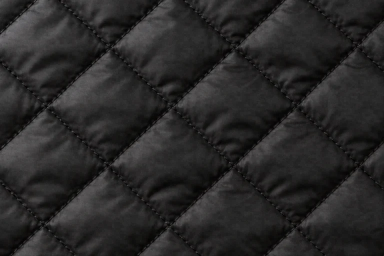 Close-up of black diamond-quilted nylon