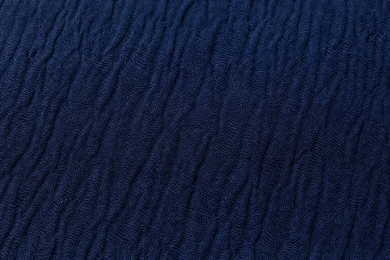 Close-up of navy silk georgette with a crinkled crepe surface