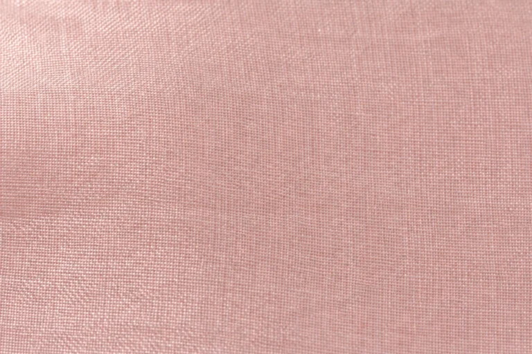 Close-up of blush-pink silk habotai with a fine, smooth plain weave