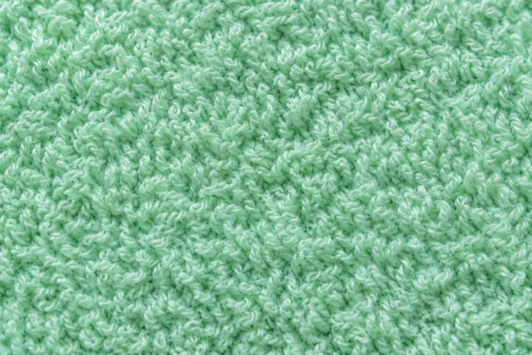 Close-up of mint cotton terry towelling with soft loops